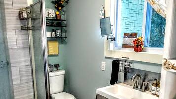 Shower, hair dryer, towels, toilet paper