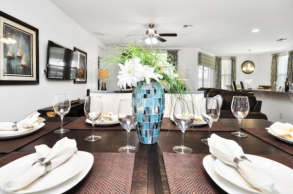 Enjoy meals in this stylish dining area with a beautifully set table and elegant centerpiece.