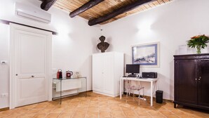 A room with a white door, a white cabinet, a desk with a computer, a chair, and a dark wooden cabinet. - Palazzo Marigliano - Don Aniello (Napoli)