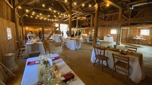 A rustic barn-style venue with wooden beams, string lights, and tables set for a formal event. - Wonderful Views and Mountain Charm and on Beautiful 50 Acre Farm (Thornton)