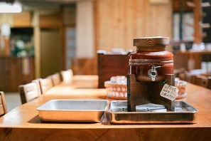 A wooden table with a coffee machine and metal trays. - Kamanuma Onsen Daikisen (Kiso)
