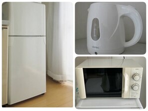 Kitchen essentials include a refrigerator, coffee maker, and microwave for convenient food preparation and storage.