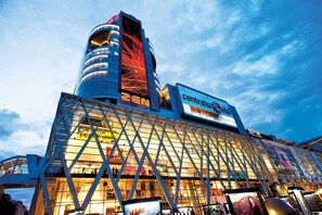 A modern building with a curved glass facade and a prominent sign for the Central Hotel. - Oyo 688 Bangkok Hub Hostel (Bangkok)