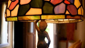 Luminária de vitral com silhueta de uma mulher.