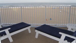 A balcony with two white lounge chairs and a view of the beach and ocean. - El Capitan, Ocean City, MD, USA unit 203 located on the boardwalk and ocean at 4th street (Ocean City)