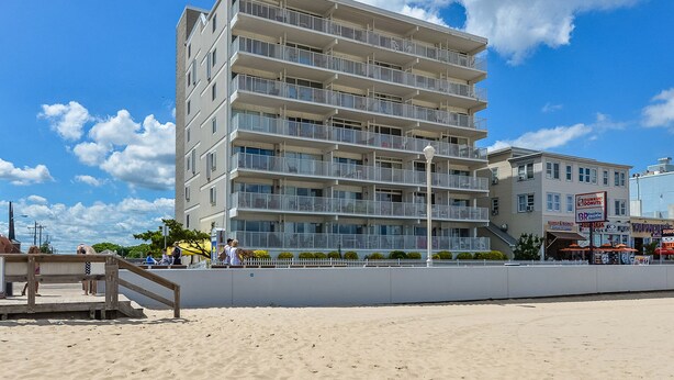 A multi-story hotel with balconies, located near a beach. - El Capitan, Ocean City, MD, USA unit 203 located on the boardwalk and ocean at 4th street (Ocean City)