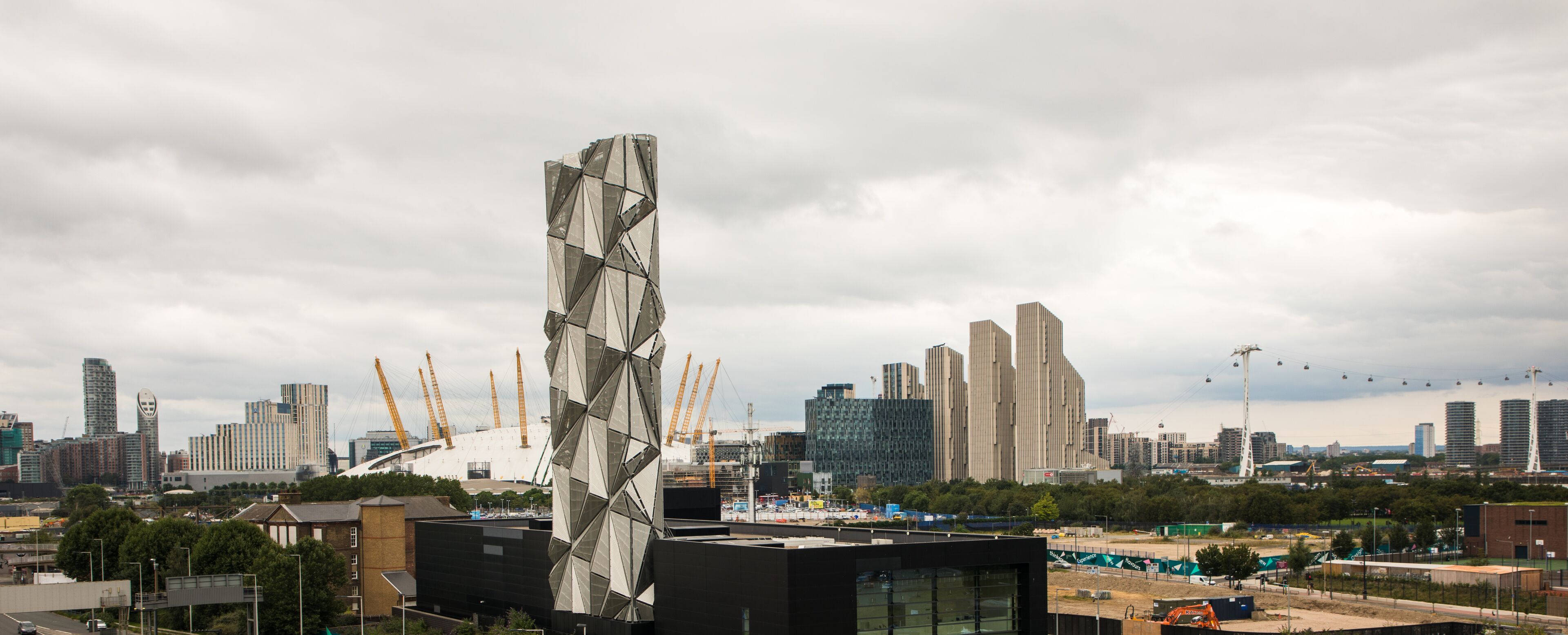 A modern cityscape with a prominent building featuring a geometric facade.