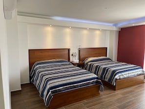 Deluxe Quadruple Room | Minibar, in-room safe, laptop workspace, free WiFi