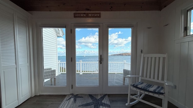 A wooden interior with a view of the sea through a glass door. - Spectacular views, close to down town Rockland (Owls Head)