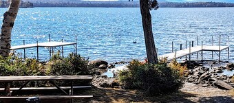 Lakefront home with private dock, mooring, pebble beach, grill, & firepit