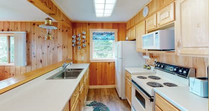 Lakefront home with private dock, mooring, pebble beach, grill, & firepit