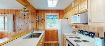 Lakefront home with private dock, mooring, pebble beach, grill, & firepit