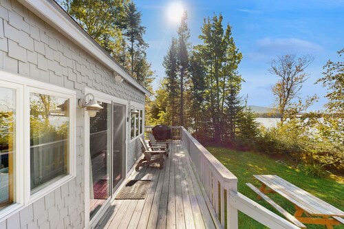 Lakefront home with private dock, mooring, pebble beach, grill, & firepit