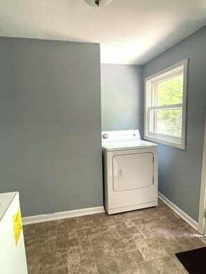 A laundry room with a washing machine, a window, and a door. - Beach Bliss, Pet Friendly Retreat, With Hot Tub Near Lake MI (Benton Harbor)