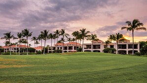 A golf course with a building in the background.