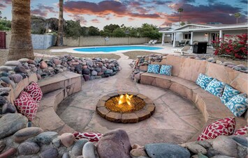 Large fire pit area with seating for up to 10 people