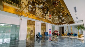 A spacious lobby with a high ceiling, reflective marble floor, and modern seating arrangements. - Elegant and Stylish Studio Menteng Park Apartment (Jakarta)
