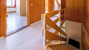 A wooden interior with a staircase, a door, and a window. - Hauswurz by Interhome (Gwatt (Thun))