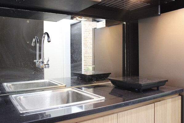 Room | Private kitchenette | Fridge, stovetop, cookware/dishes/utensils - Modern 2BR Apartment at Grand Asia Afrika Residence (Bandung)