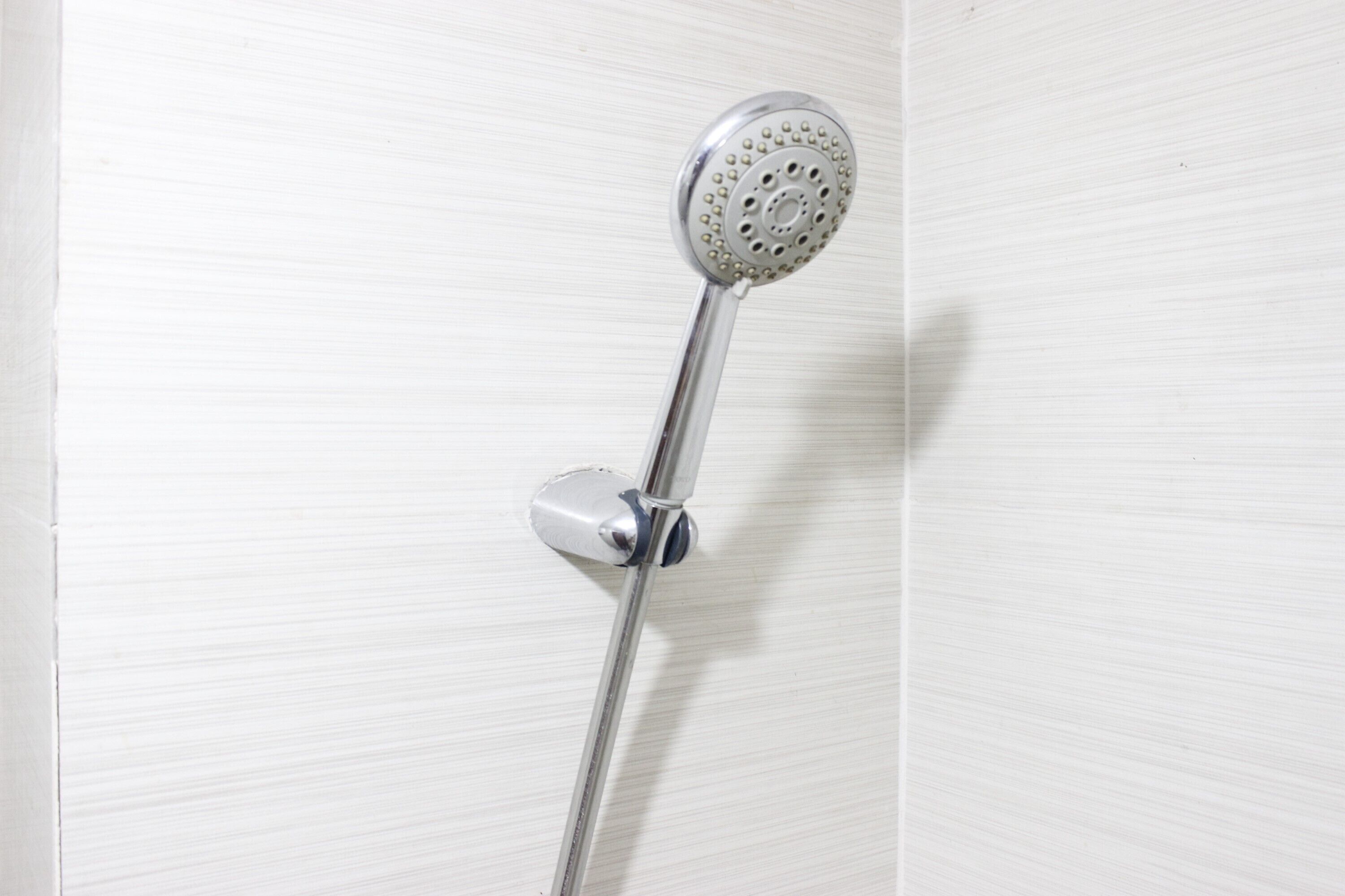 A showerhead mounted on a wall.