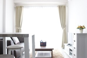 Room | Living room | TV - Simply Minimalist 2BR Gateway Pasteur Apartment (Cimahi)