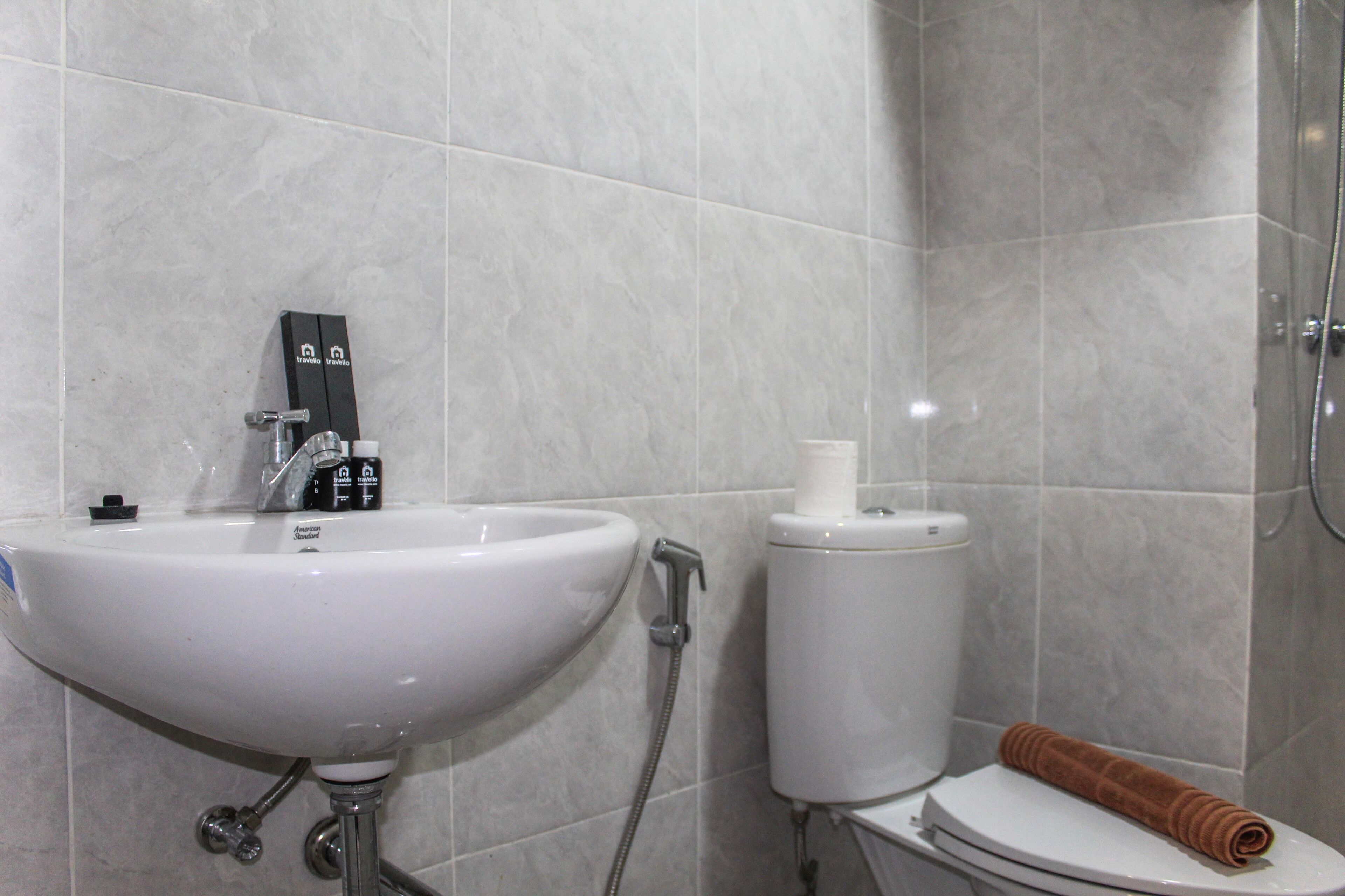 A bathroom with a sink, toilet, and shower.