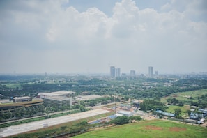 A cityscape with a mix of modern buildings and green spaces.