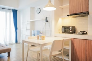 Enjoy meals in this kitchen with an oven and dining area for two.