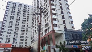 A high-rise building with multiple balconies and a commercial ground floor. - Chic Studio at Serpong Green View Apartment (South Tangerang)
