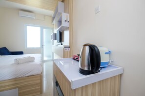 Room | Private kitchenette | Fridge, stovetop, cookware/dishes/utensils - Elegant Studio Apartment @ Bogorienze Resort (Bogor)