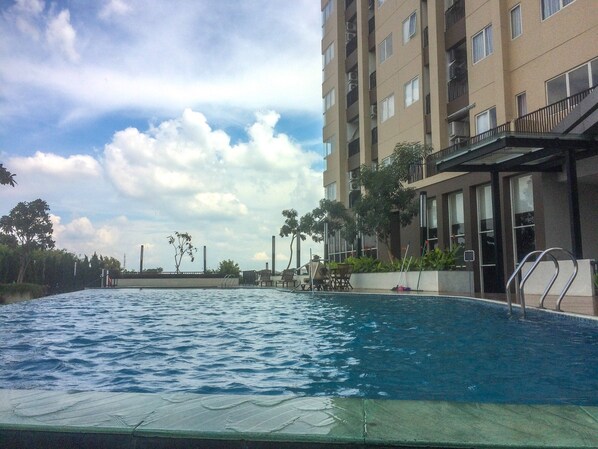 Outdoor pool - Warm and Cozy Studio at The Oasis Apartment (Cikarang)