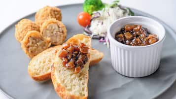 A plate with bread, a small bowl of sauce, and a side salad.