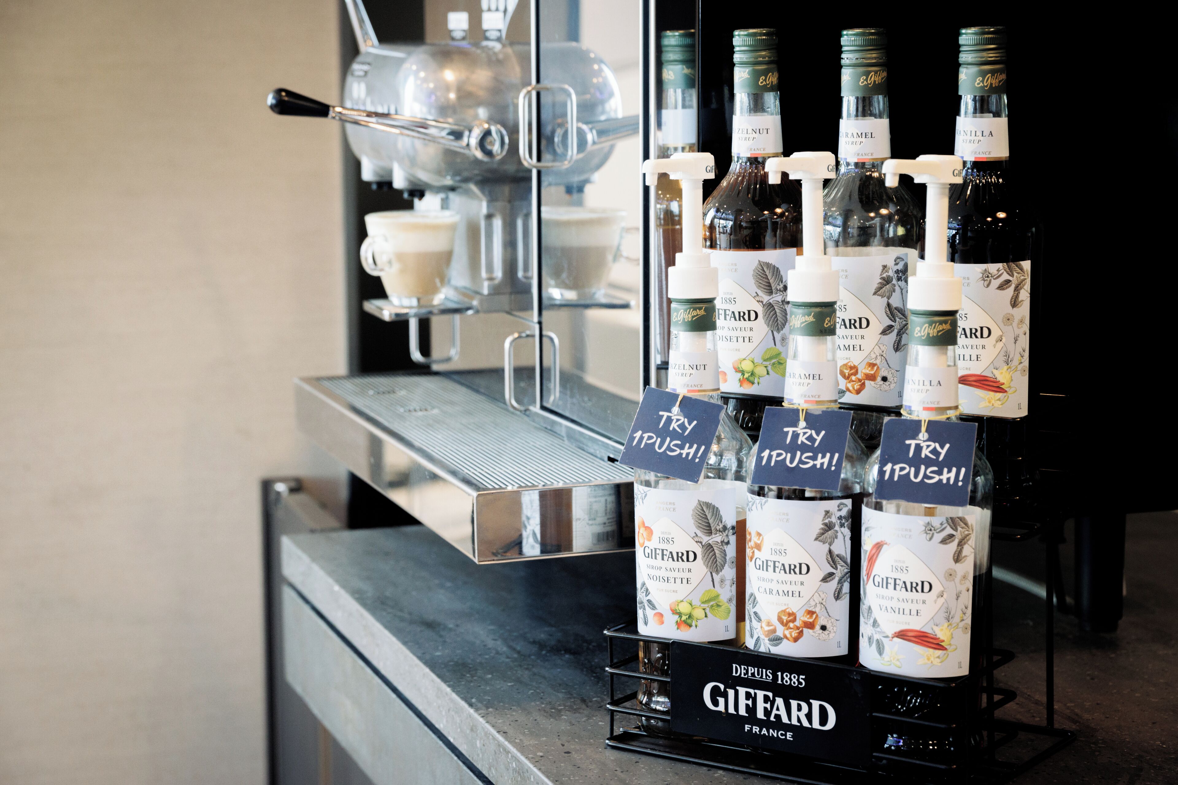 A display of Giffard brand liqueurs with 'TRY 1 PUSH!' tags.