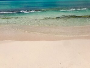 A beach with clear turquoise water and a sandy shore. - Spring Bookings! ANIDELE ZEN -2BR on Golf Course. Near Beach w/ Pool, Golf, BBQ. (Rockley Golf and Country Club)