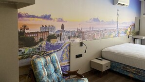 A hotel room with a large cityscape mural, a bed, a chair, a nightstand, and an air conditioning unit. - Ofuro World Hotel Spa (Izmir)