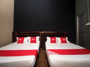 A hotel room with two beds, each with white bedding and red accents, including pillows and a red runner. - OYO 90094 Hi Inn 3 (Sibu)