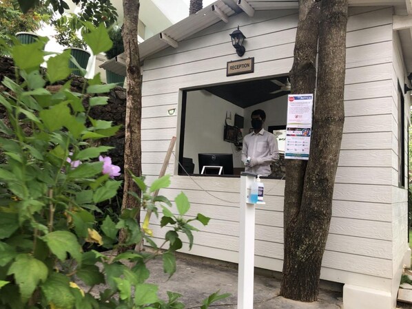 A reception area with a sign labeled "RECEPTION" and a notice board.