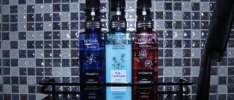 Three bottles of Episode hair care products on a shelf against a tiled wall.