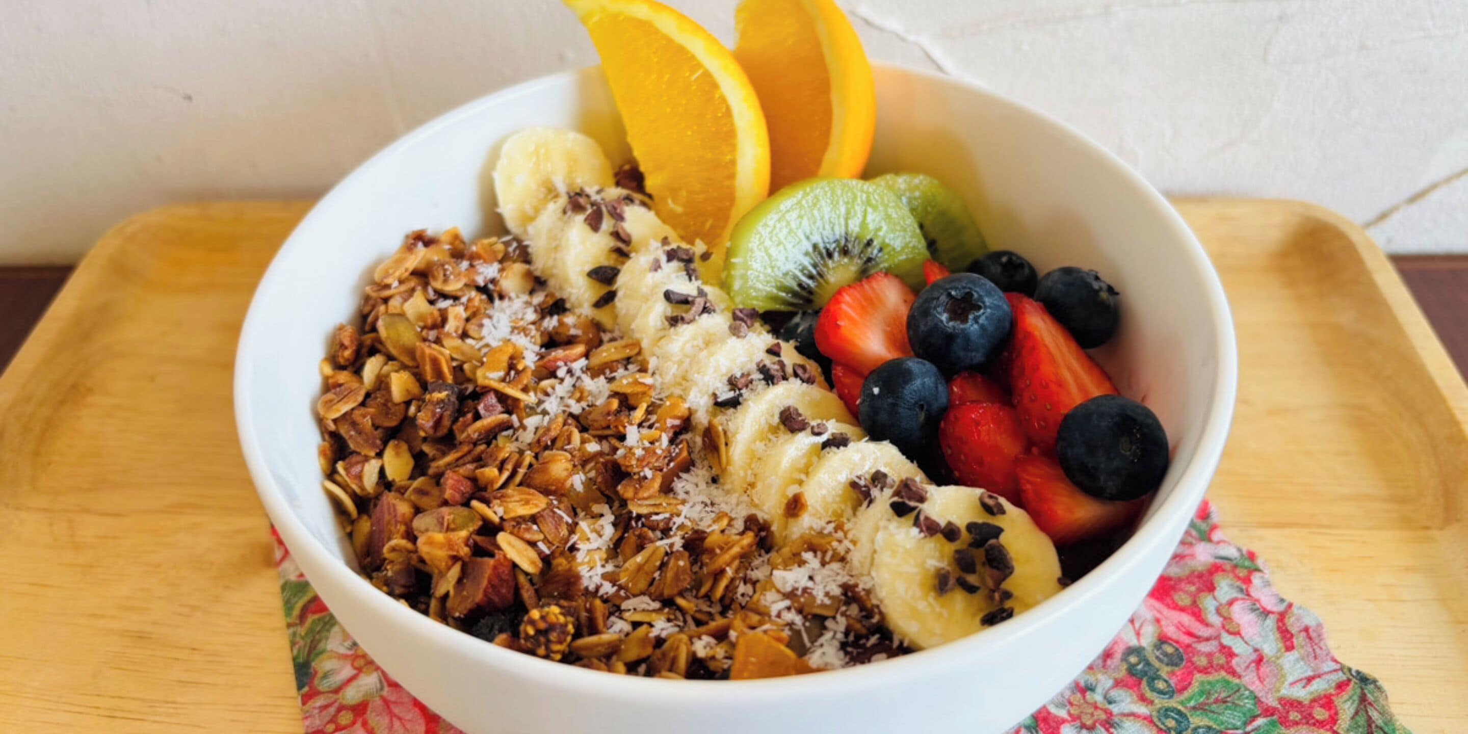 A bowl of granola with fruits and nuts.