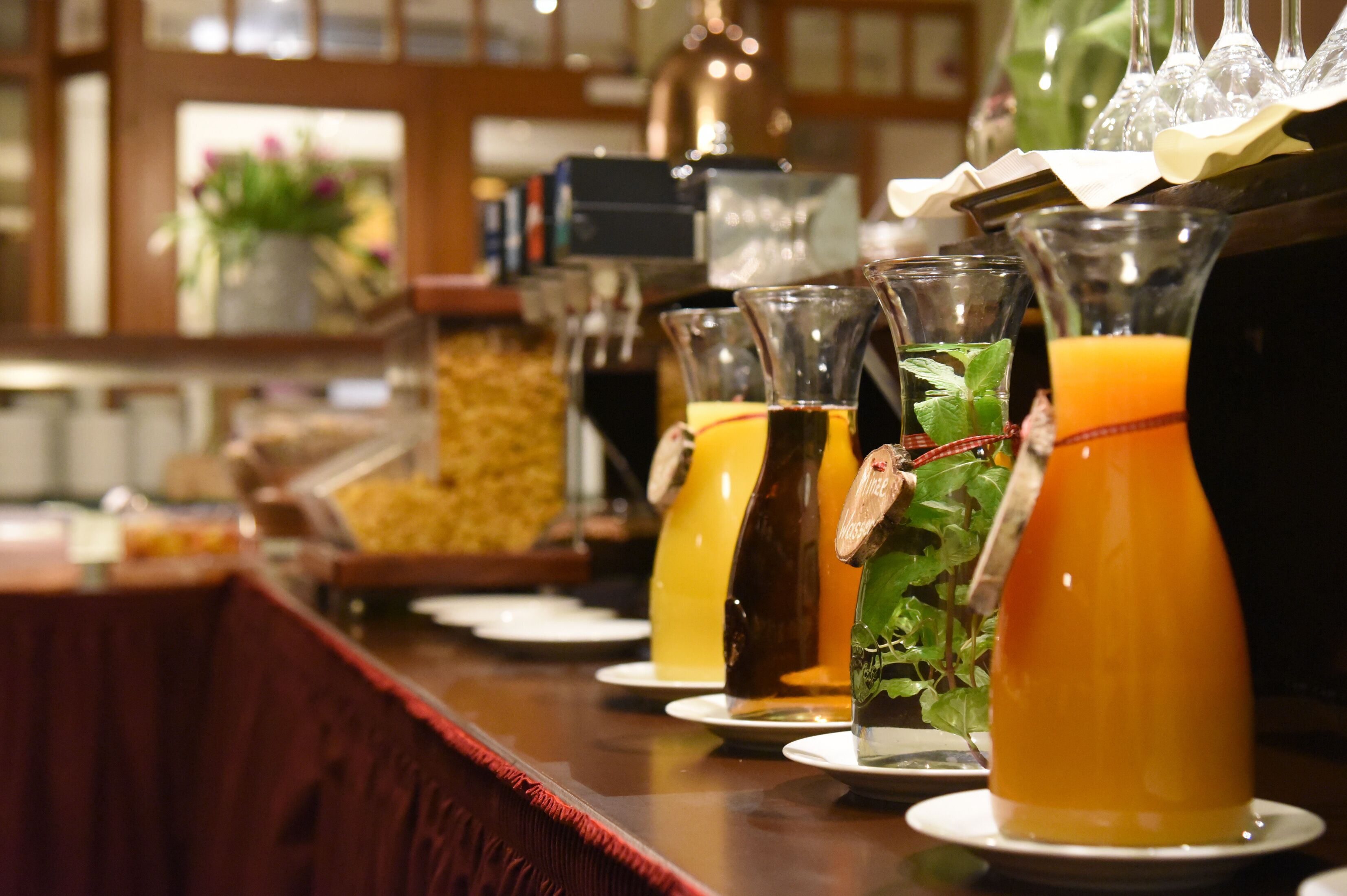 A bar area with a variety of drinks and a buffet.