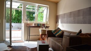 Un salon avec un canapé en cuir, une table basse et une bibliothèque.