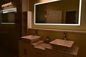 A bathroom with two white vessel sinks, a large mirror, and a shower area. - Sleep 12 in Chic Home Near Downtown, State Fair Grounds and Newfields Art Museum (Indianapolis)