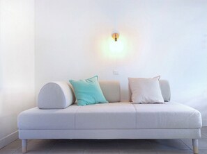 Relax in a serene space with a comfortable sofa and ambient lighting.
