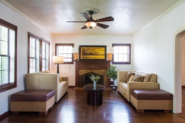A living room with two sofas, a coffee table, and a fireplace.