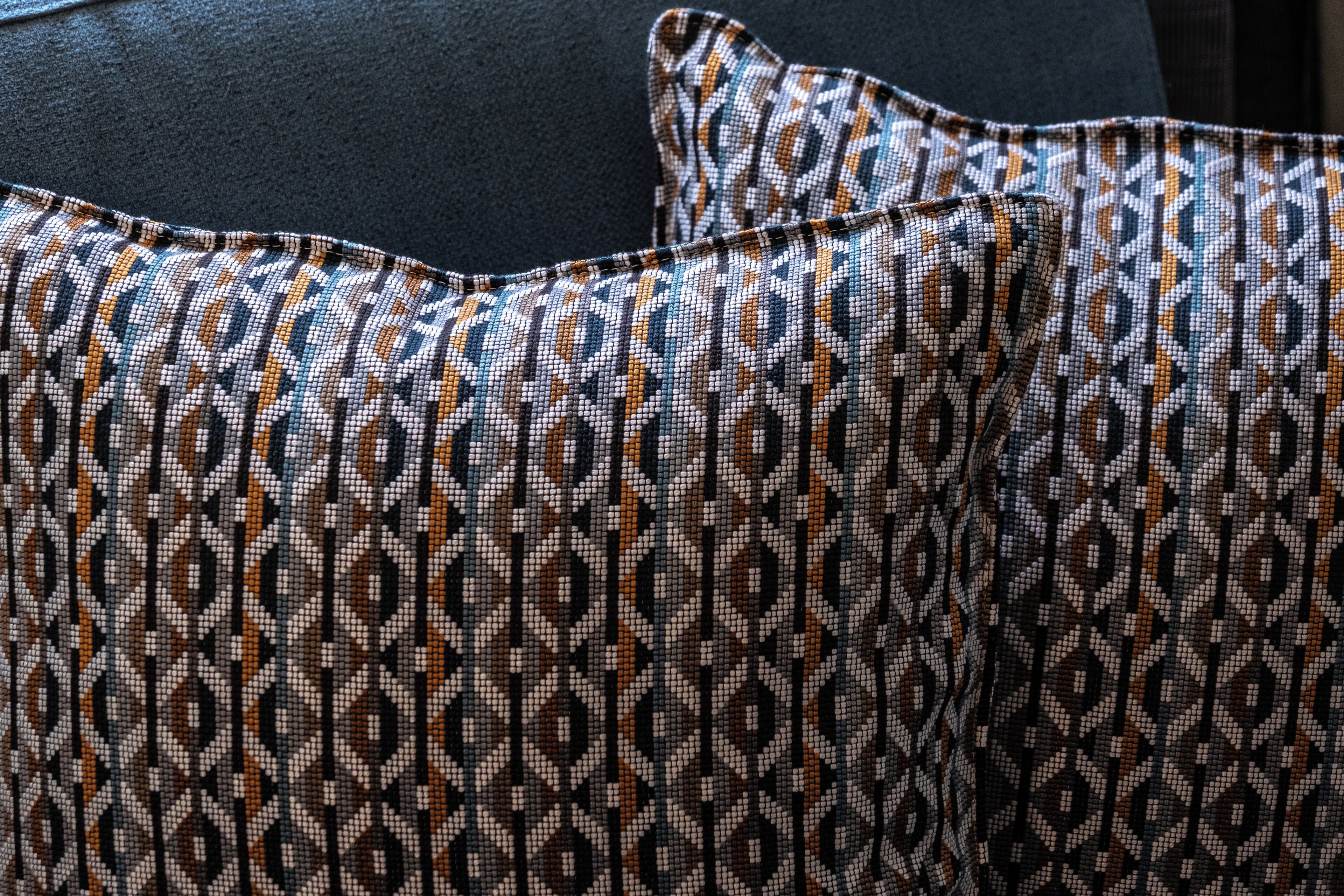 A close-up of a patterned pillow with a geometric design.