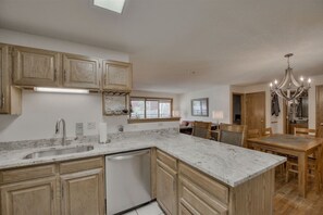 Enjoy meals in the spacious kitchen with a central island, dishwasher, and ample counter space.