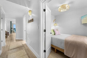 Cozy 3rd bedroom w/ a full bed and ceiling fan. Room to stow away luggage under the bed.