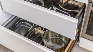 A kitchen drawer with various cookware and utensils.