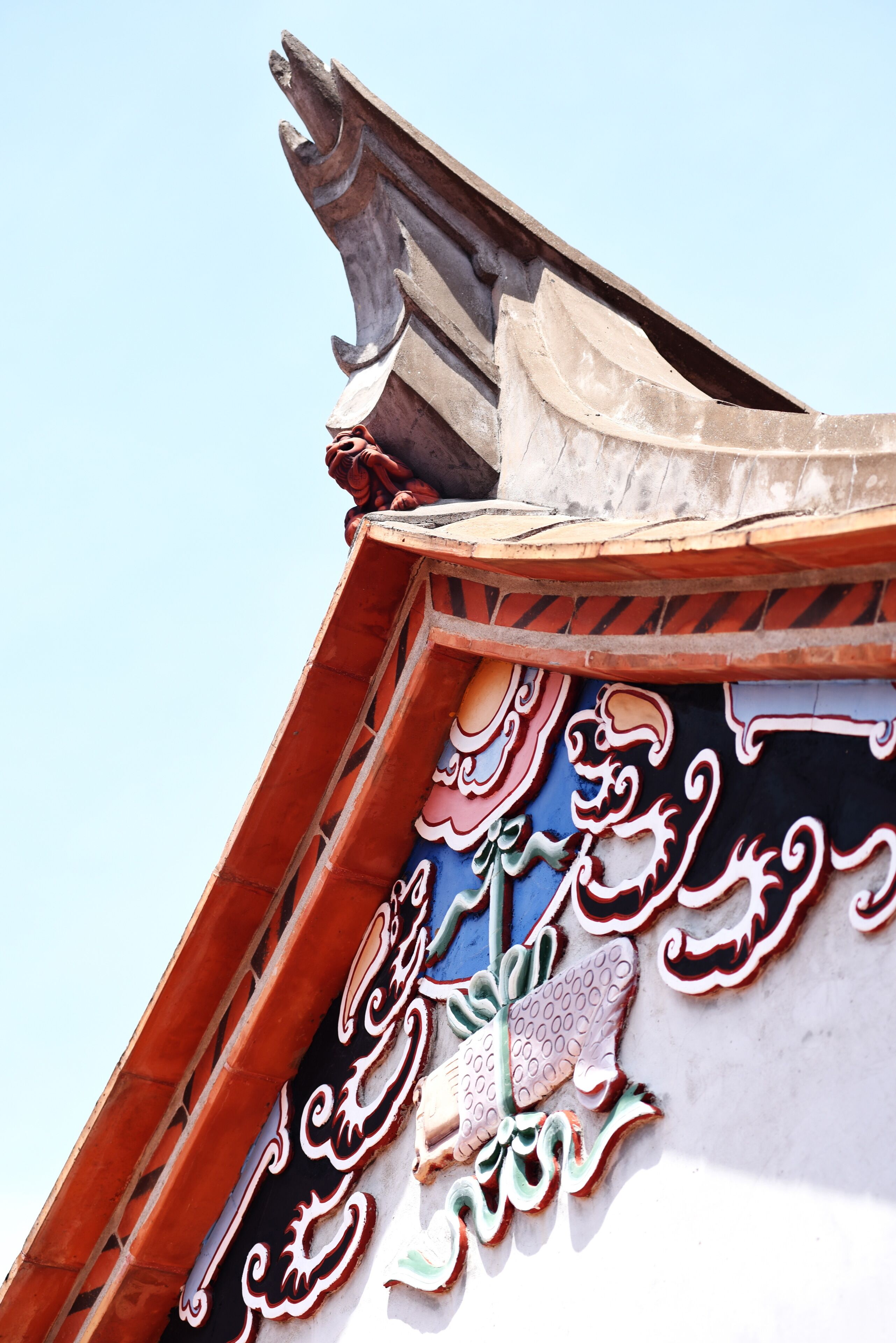 A traditional architectural structure with ornate carvings and a steeply pitched roof.