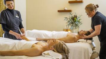 Relax and rejuvenate in our serene spa room, featuring a massage table and expert therapists.